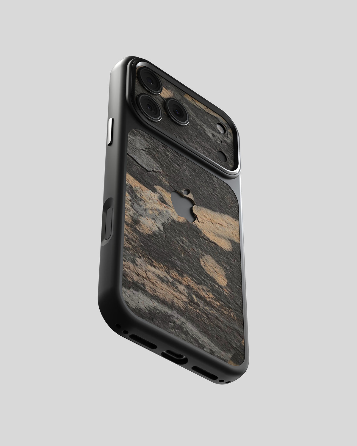 Slate Case Pro Transocean, vista inclinada: pizarra oscura con manchas bronce doradas en marco negro, pizarra también en el módulo de cámara