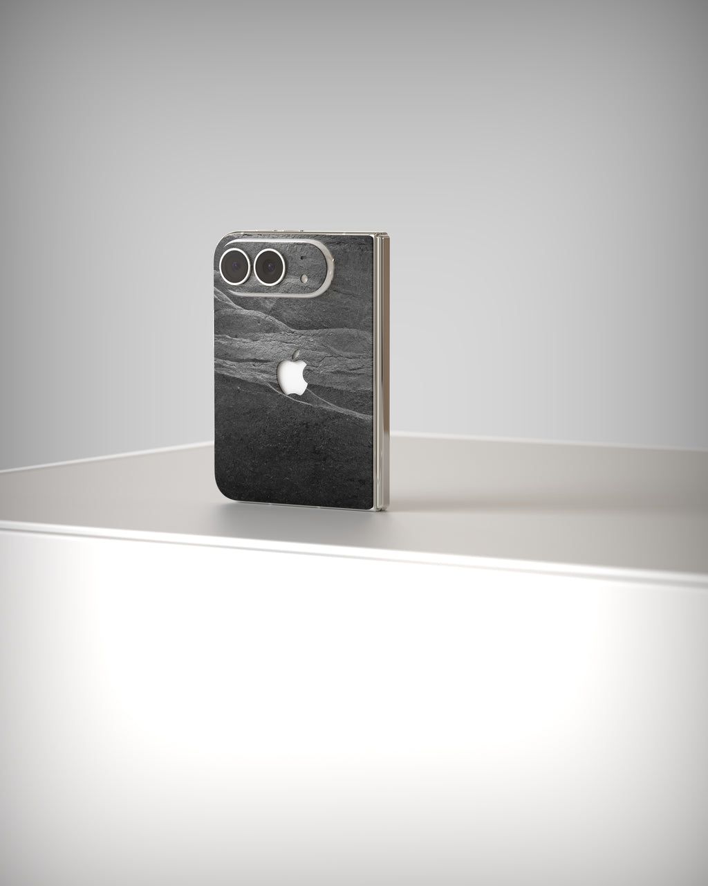iPhone Duo with Black Rock slate skin, slightly from the side on a light surface