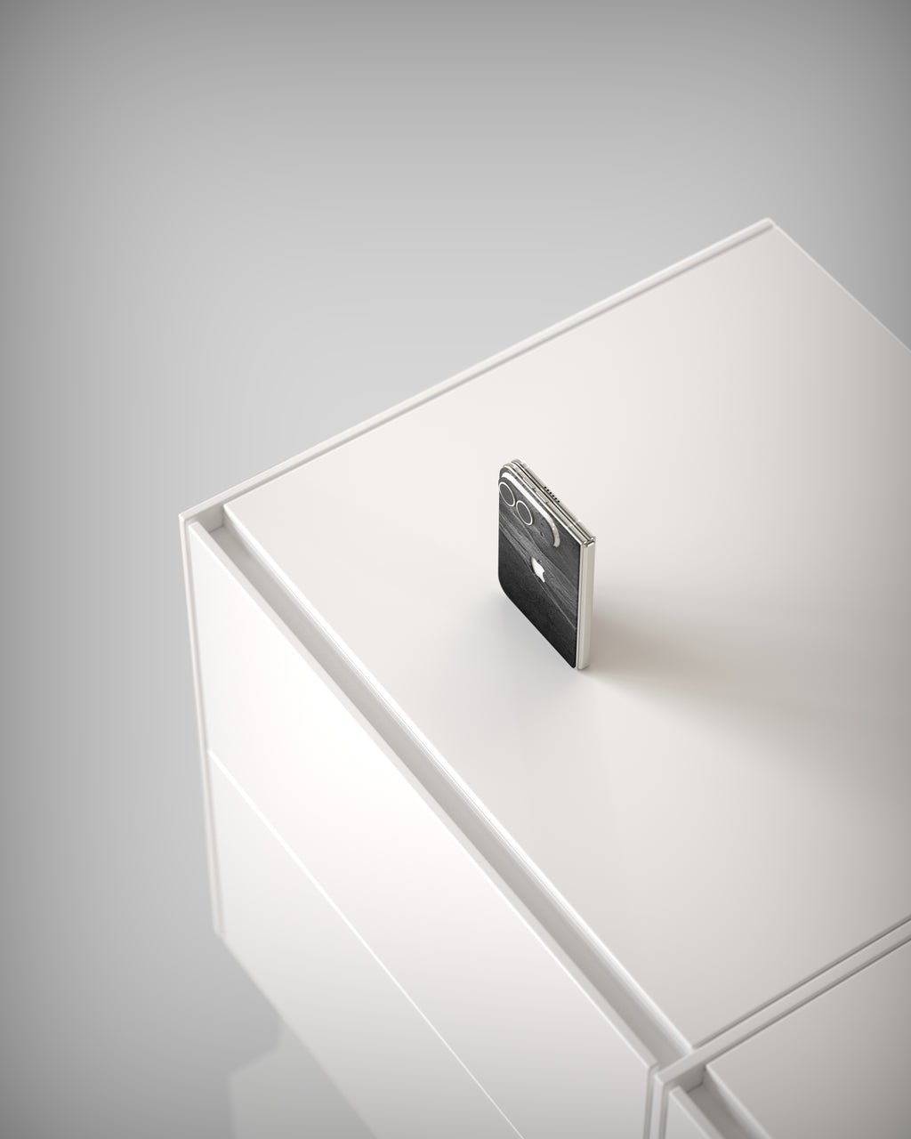From above: iPhone Duo with Black Rock slate skin on a white cabinet
