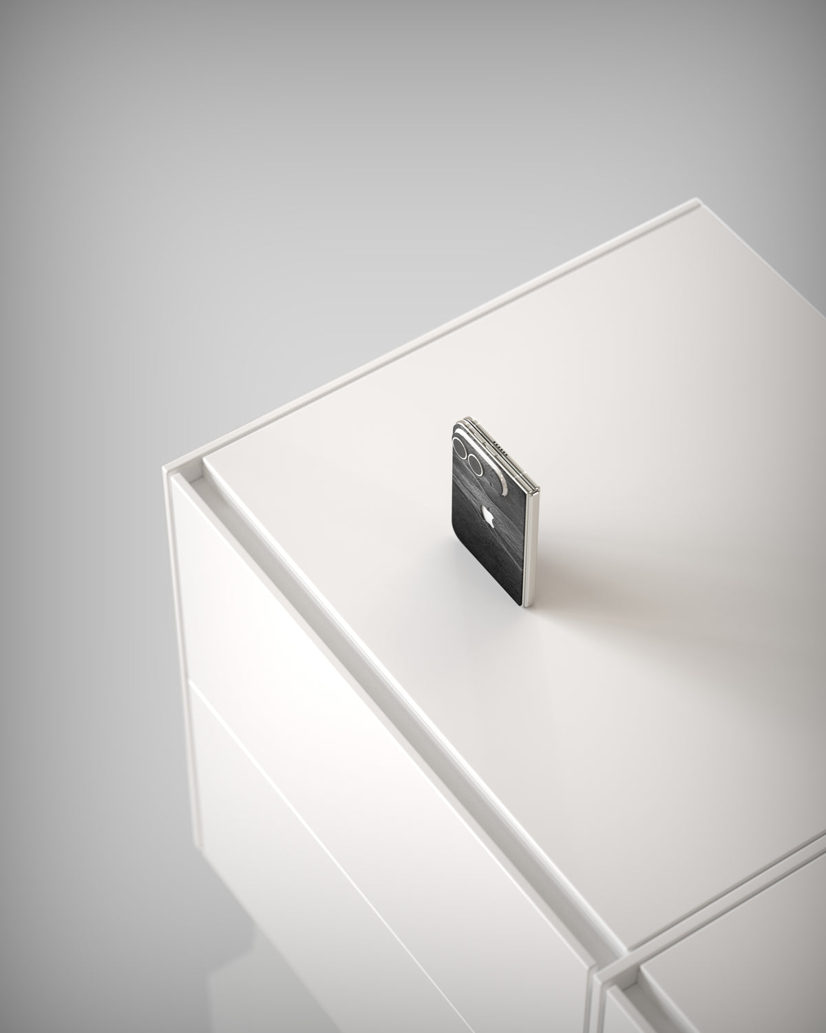 From above: iPhone Duo with Black Rock slate skin on a white cabinet