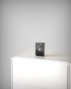 iPhone Duo with Black Rock slate skin, standing upright on a sideboard
